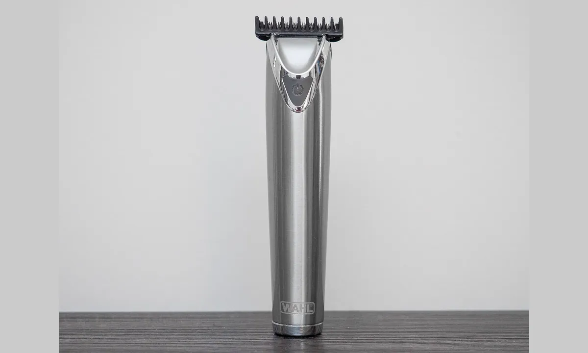 Cordless hair trimmer standing upright on a plain background.
