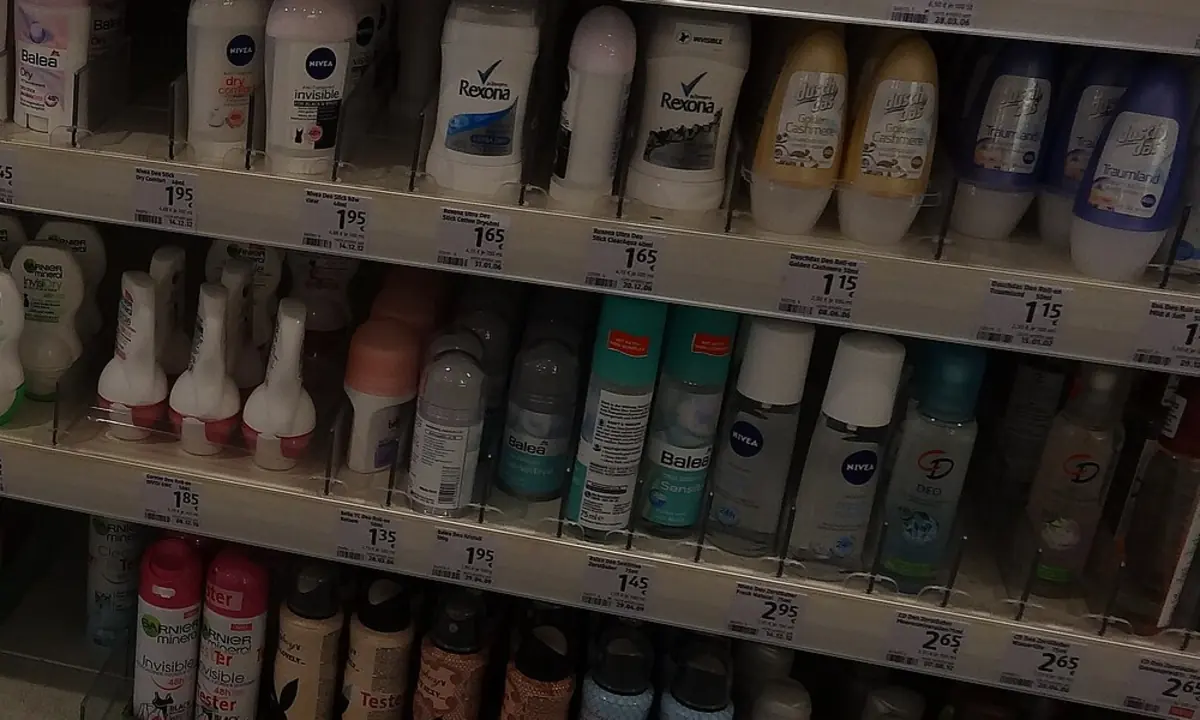Long retail aisle lined with deodorant and antiperspirant packaging.