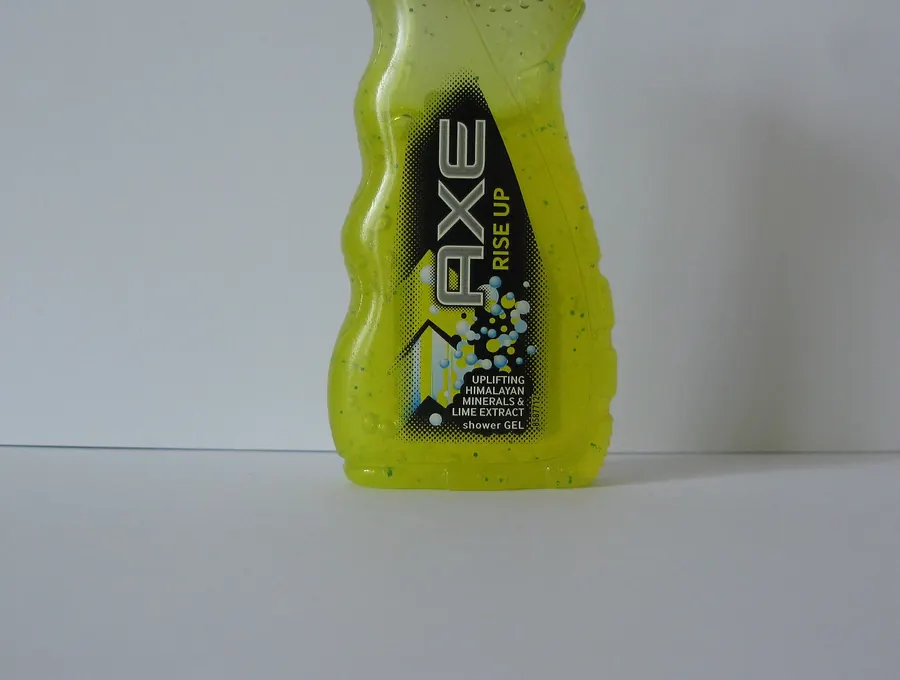 Bottle of AXE body wash standing on a plain background.