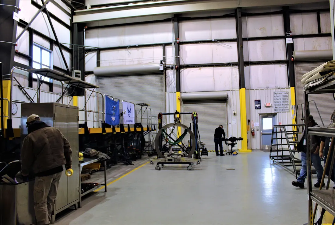 Loading bay inside an industrial facility with the roller door open and staff working.