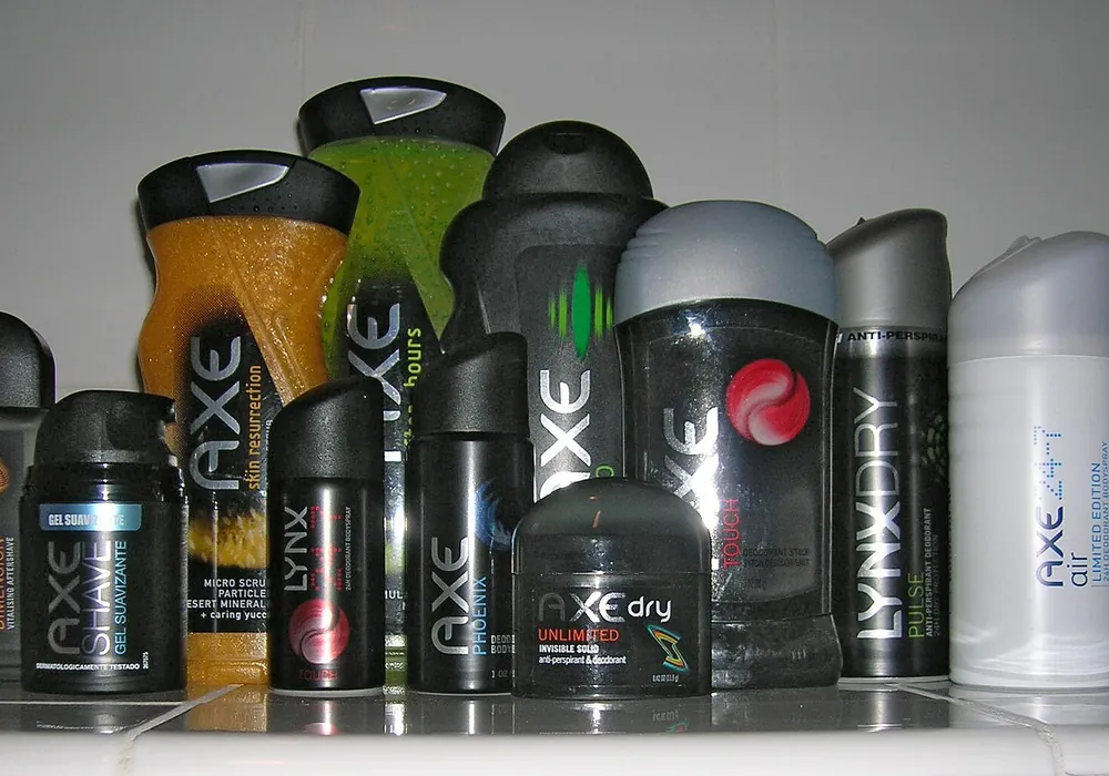 Shelf lined with AXE body spray cans, deodorant sticks and body wash bottles.