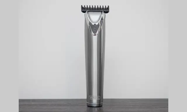 Cordless hair trimmer standing upright on a plain background.