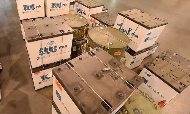 Cases stacked in rows on a warehouse floor awaiting dispatch.